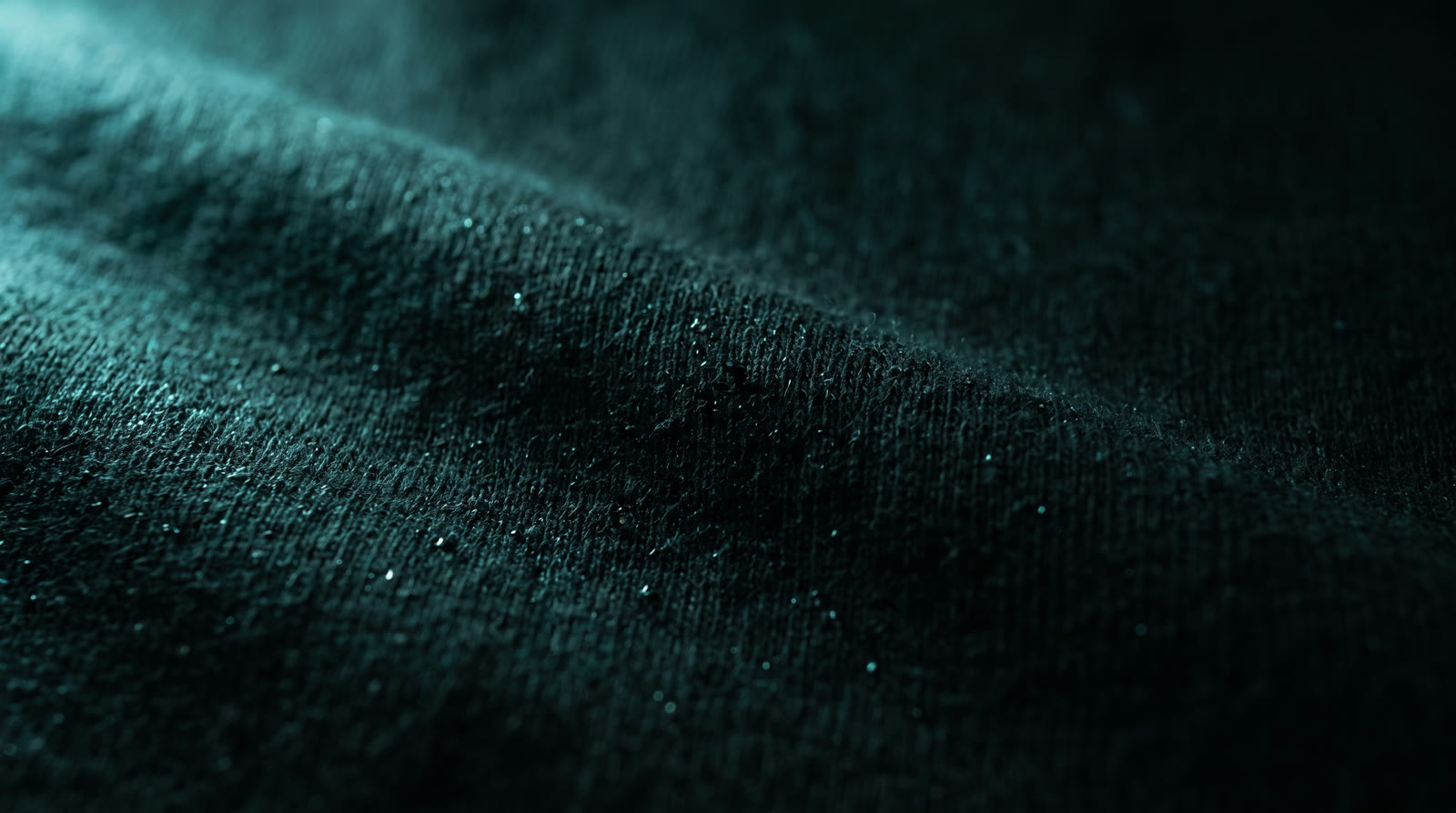 Macro of heavyweight black cotton fibers with mist.
